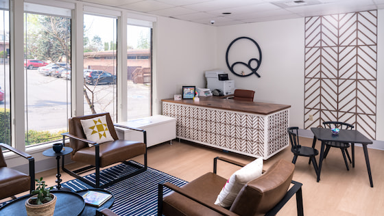 Inviting waiting room with soft leather chairs and natural light