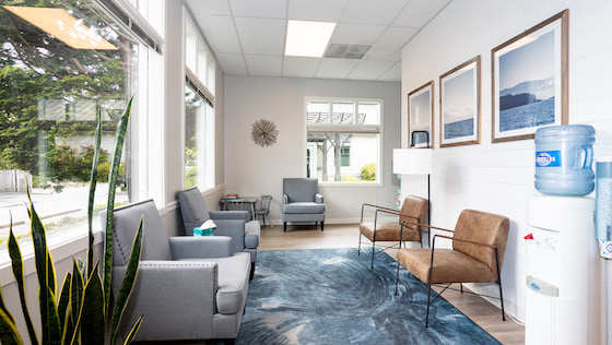 Inviting waiting room with soft chairs and natural light at the Quilted Health Tacoma and Pierce County pregnancy care clinic